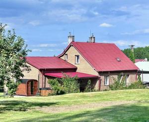 a large red roofed house with a red roof at Chata Lipa in Trstená