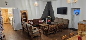 a living room with a couch and a fireplace at Chata Lipa in Trstená