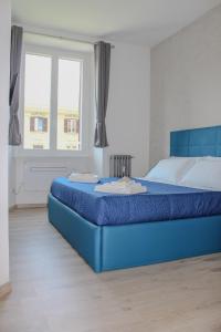a blue bed in a bedroom with a window at SunnyCornerinRHome in Rome