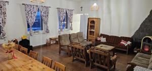 a living room with a table and chairs at Chata Lipa in Trstená
