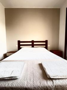 a bedroom with a bed with two towels on it at ALT alloggio turistico in Focene