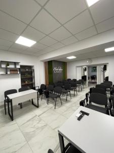a large room with tables and chairs and a chalkboard at ROCAS Hotel in Orhei