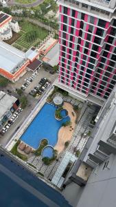an overhead view of a pool in front of a building at Sorici Studio at Bella Tower in Surabaya