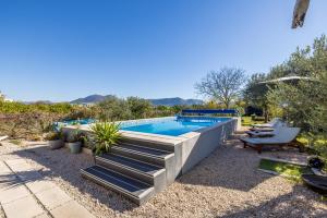 a backyard with a swimming pool with stairs leading up to it at Holiday house Goran, Opuzen in Opuzen