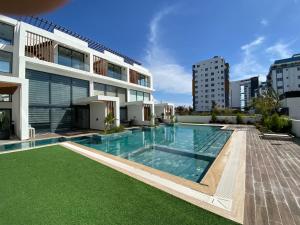 a swimming pool in front of a building at Loft One Bedroom with Shared Private Pool in Aglantzia