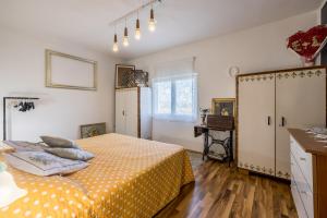 a bedroom with a bed with a yellow blanket at Holiday house Goran, Opuzen in Opuzen +24 photos