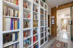 a library with white shelves filled with books at Holiday house Goran, Opuzen in Opuzen