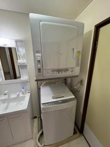 a small kitchen with a sink and a microwave at Zen house 2 in Okayama +43 photos