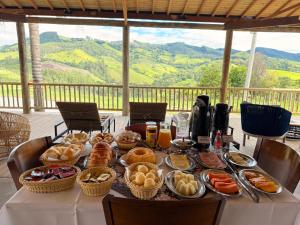 a table with breakfast foods on it with a view at Montinni Hotel in Socorro