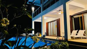 a house with a swimming pool next to a house at Hanamitsu Hotel & Spa in Garapan