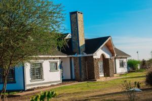 a house with a chimney on top of it at Andu Kuboiye Homes in Kimana +11 photos