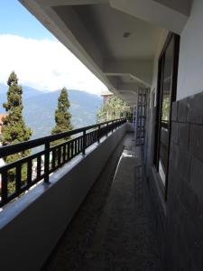 a balcony with a view of the mountains at Hotel Kabur in Pelling