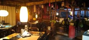 a restaurant with tables and chairs in a room at Hotel Kabur in Pelling