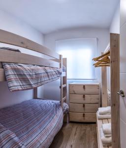 a bedroom with a bunk bed and a dresser at Ca La Josefa in Balaguer