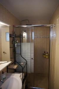 a bathroom with a shower and a sink at Mansion Alexandri in Hydra +65 photos