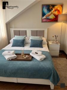 a bedroom with a bed with two towels on it at Apartamenty Przemyśl in Przemyśl +46 photos