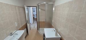 a bathroom with a sink and a toilet and a shower at Apartmány U BERANA in Česká Lípa +23 photos