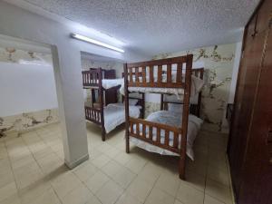 a room with two bunk beds in a room at WeniZani Backpackers Hostel Nairobi in Nairobi