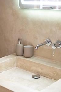 a bathroom sink with two cups on a counter at La parenthèse lilloise in Lille +2 photos