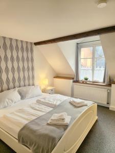 a bedroom with a large bed with towels on it at Weingut Caspari, Familie Eggert in Traben-Trarbach