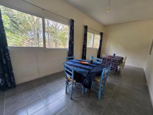 a dining room with a table and chairs and a window at La Maison Ardiana in Oussouye