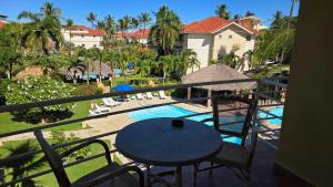 a balcony with a table and chairs and a pool at Ocean Dream in Cabarete
