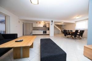 a living room and kitchen with a table and chairs at Apartment Dea 3 Spacious Lower-Level Apartment in Crikvenica