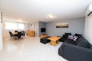 a living room with a couch and a table at Apartment Dea 3 Spacious Lower-Level Apartment in Crikvenica