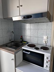 a kitchen with a sink and a stove at Elia II in Kondoliánika