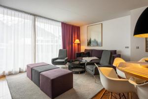 a living room with a couch and a table at Quality Hosts Arlberg - Hotel ANTON in Sankt Anton am Arlberg