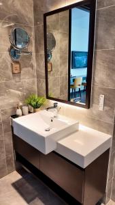 a bathroom with a white sink and a mirror at Sapphire Residence Hạ Long in Ha Long +59 photos