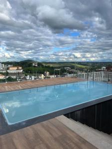 a large swimming pool on the roof of a building at Studio Sereno in Barbacena