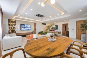 a living room with a wooden table and chairs at Saka in Lekki