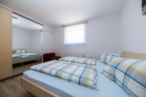 a bedroom with two beds and a mirror at Apartment Dea 3 Spacious Lower-Level Apartment in Crikvenica