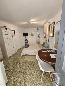 a bedroom with a bed and a desk and a table at Terra Nova in Mikonos