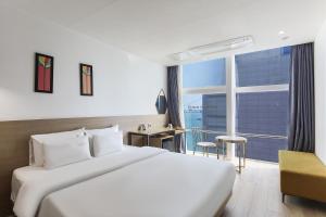 a hotel room with a bed and a large window at Gwanganri HOTEL OCEANVIEW in Busan +158 photos