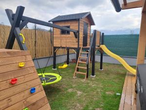 a playground with a slide and a play structure at Chata Za Studeným potokom in Habovka
