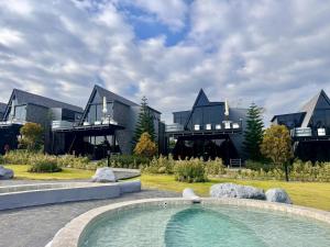 a large house with a swimming pool in front of it at ฟูจิจันท์ fujijun cafe&resort in Ban Na Khieo