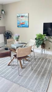 a dining room with a glass table and chairs at Little Gem in Swanage