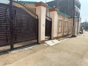 a black fence with a gate in front of a building at Riskla hotel Near-Ram Mandir 700M in Ayodhya
