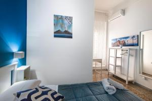 a blue and white bedroom with a bed at Mellos B&B in Naples