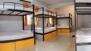 a room with four bunk beds in a dorm at Sainik Dormitory and Room Service in Lucknow