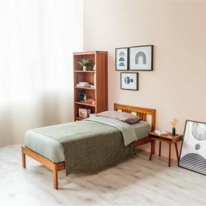 a bedroom with a bed and a book shelf at Sainik Dormitory and Room Service in Lucknow