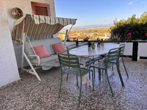 a table and chairs and an umbrella on a patio at Mediterranean House in Valencia in Valencia