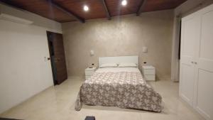 a bedroom with a large bed and two night stands at Casa Cappuccini in Comacchio