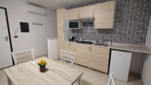 a kitchen with a table with a vase of flowers on it at Casa Cappuccini in Comacchio