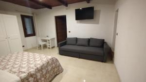 a living room with a couch and a bed at Casa Cappuccini in Comacchio