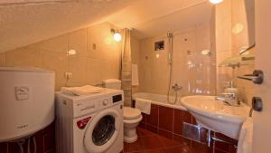 a bathroom with a washing machine and a sink at Old Town Stay by Ivo in Trogir +39 photos