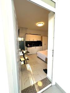 a view of a room with a bed and a kitchen at Taku Rooms Vlora in Vlorë