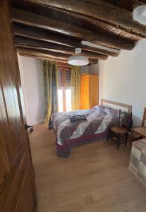 a bedroom with a bed and a wooden floor at Casa Jardin in Lobras